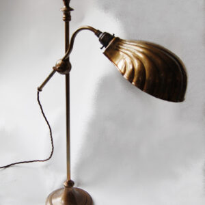 Adjustable arm table lamp with shell shade in antique finish